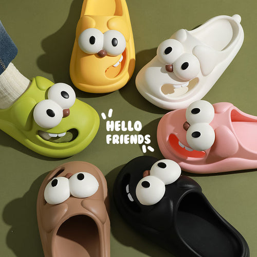 Colorful slippers with cartoonish faces on a green background