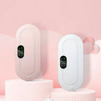Two electronic menstrual pads are shown side by side on pink display pedestals. One device is a soft blush pink, and the other is white, both with oval digital screens.