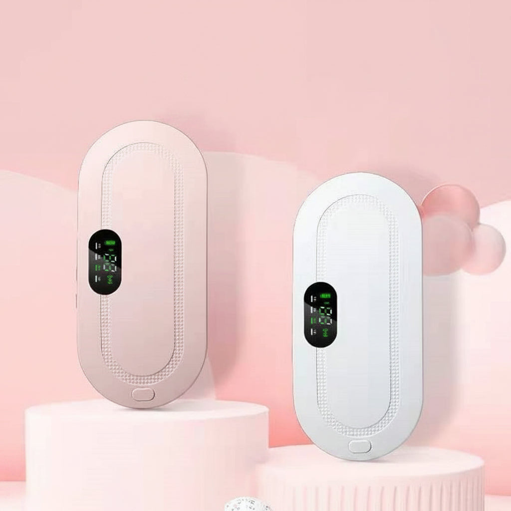 Two electronic menstrual pads are shown side by side on pink display pedestals. One device is a soft blush pink, and the other is white, both with oval digital screens.